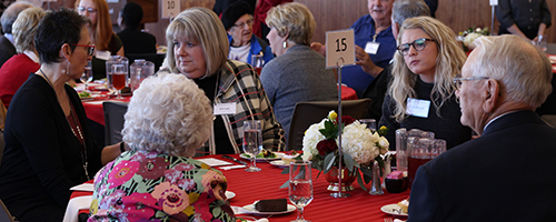 Student scholarship recipients sitting at table with donors during annual Bumpers College Scholarship Luncheon.